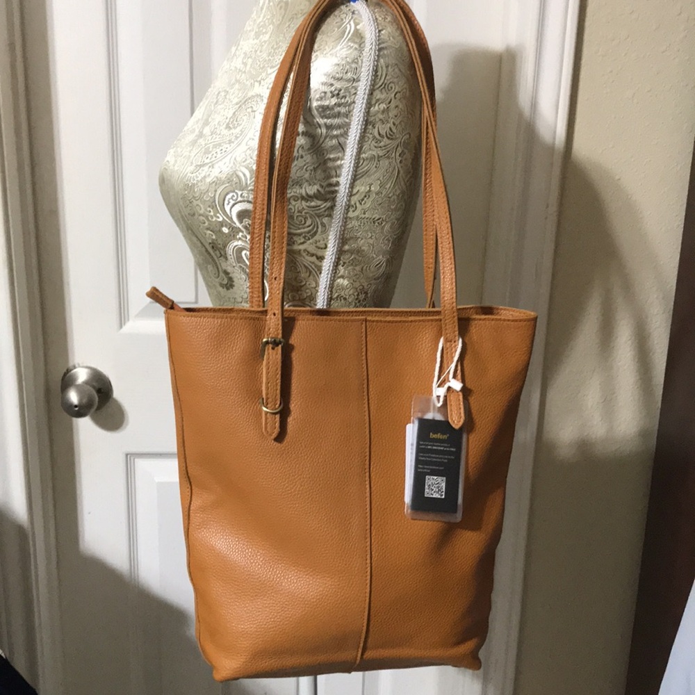 Befen leather tote with top zipper and zip slot and adjustable straps. NWT